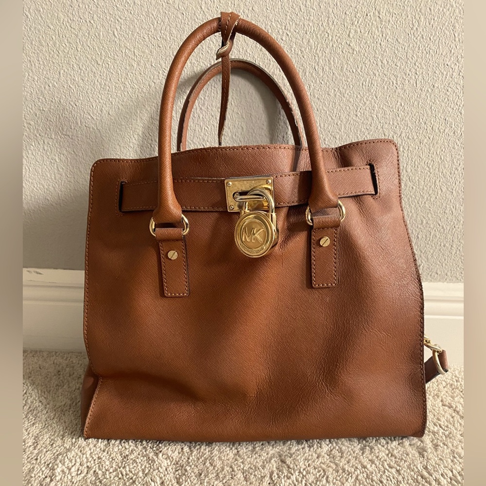 Michael Kors large tote. Minor wear and tear on hardware and handles.